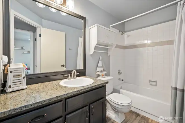 Granite countertops, updated fixtures, and tile tub surround.