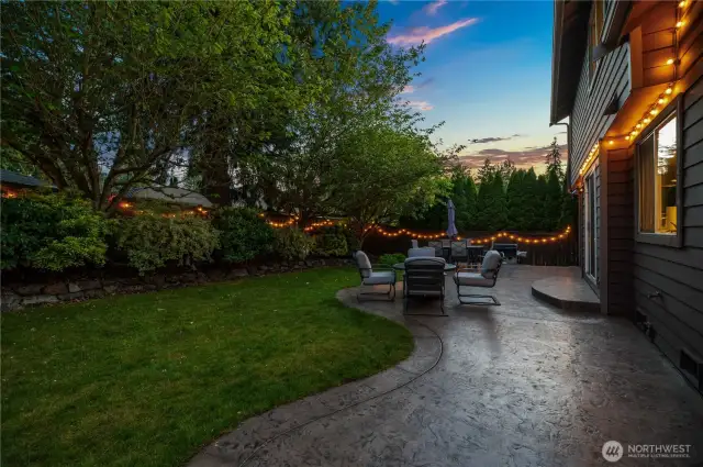 Evening glow and fire pit-ready seating make this backyard a year-round favorite.