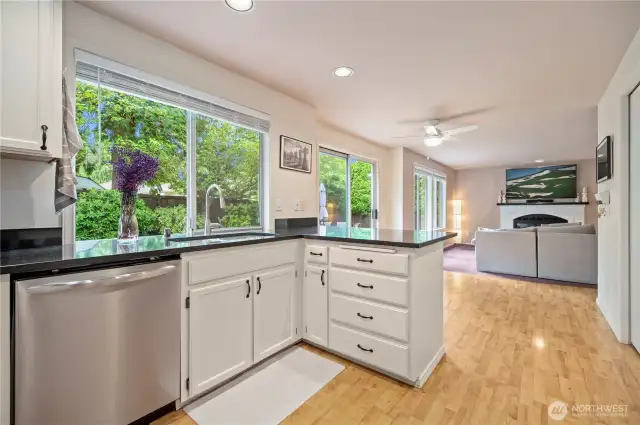Open-concept design flows from the kitchen into the family room with cozy fireplace—ideal for entertaining or relaxing at home.