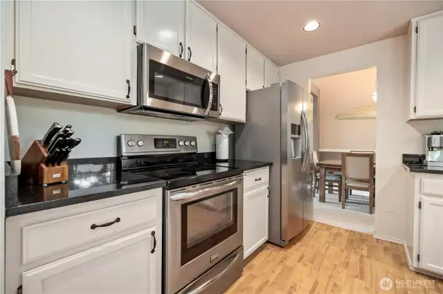 Enjoy seamless flow from the kitchen to the formal dining room, with modern appliances and a classic design for easy entertaining.