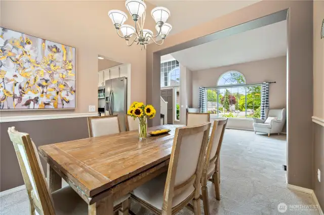 Bright and open formal dining space connects to the living room, highlighting the home’s inviting layout and natural light.