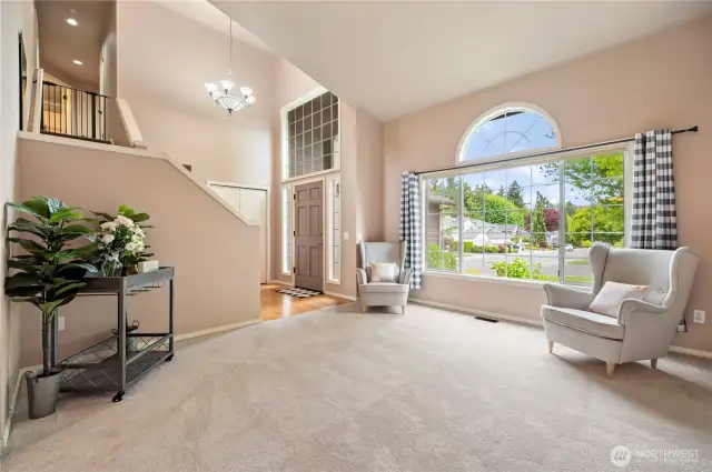 Impressive entry with soaring ceilings and a statement window that fills the space with light—welcoming and warm from the moment you walk in.