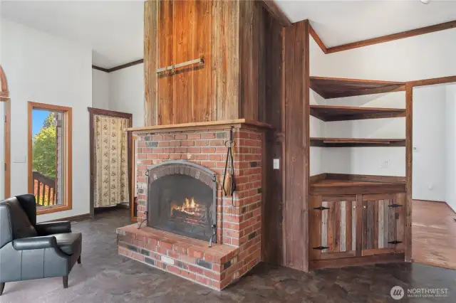 The wood-burning fireplace in the kitchen was a focal point for gatherings and a cozy place for morning coffee. Behind the curtain in the background is a pantry closet.