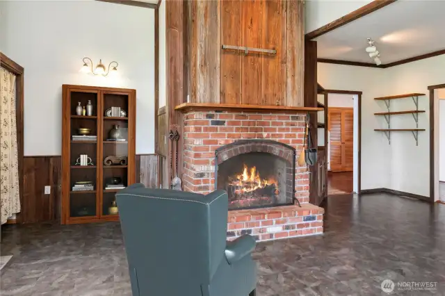 The kitchen has a French, rustic feel about it with wood trim and the wood fireplace. A forged metal rack above the fireplace can hold several pots and pans.