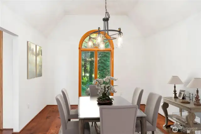 The dining room off of the kitchen is a lovely space, and the views out the window are peaceful.