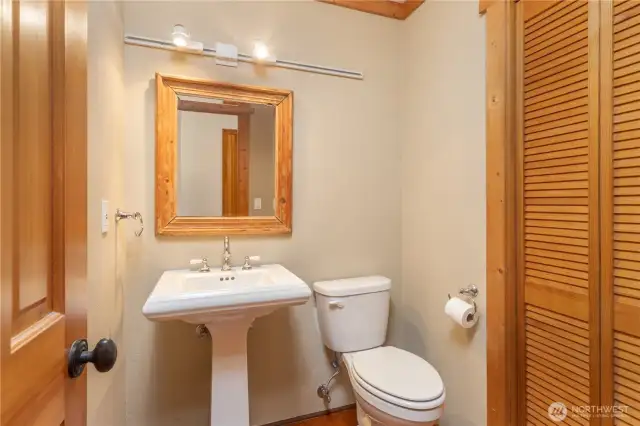 The powder room on the main level. Note the furnace is behind the bi-fold closet door.