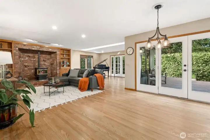 The spacious family room offers an inviting place to gather, featuring generous proportions and an easy flow for everyday living. French doors off of the music room open to the covered back deck, extending the living space outdoors and creating the perfect setting for year-round entertaining or quiet relaxation surrounded by nature.