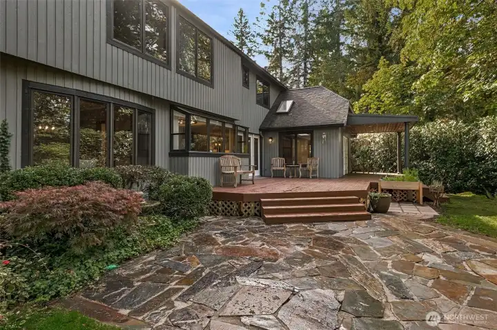 Step outside to a private back deck and flagstone patio that opens to lush greenery. It’s the perfect setting for outdoor dining, morning coffee, or peaceful reflection.