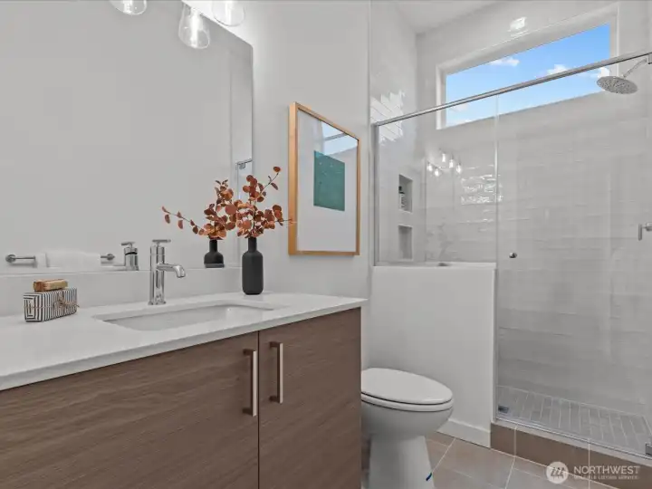 Lower level also boasts bathroom with shower. Similar model unit