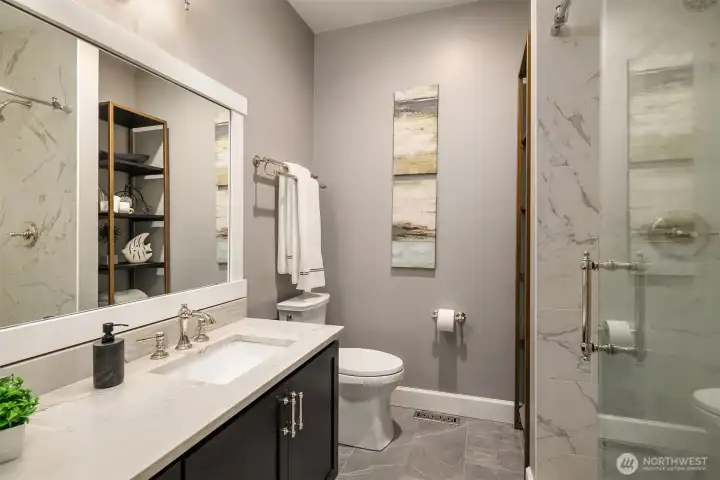 Completely remodeled hall 3/4 bath with custom vanity, lighting, tile floor and tile walk in shower