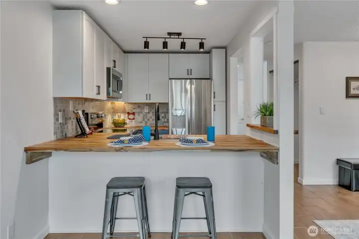 Large bar seating allow for chats while you cook.
