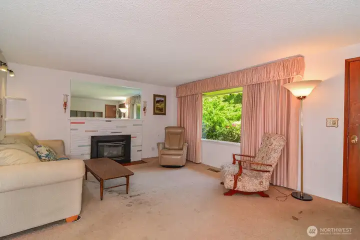 Living Room with Gas Fireplace & picture window to front garden area.