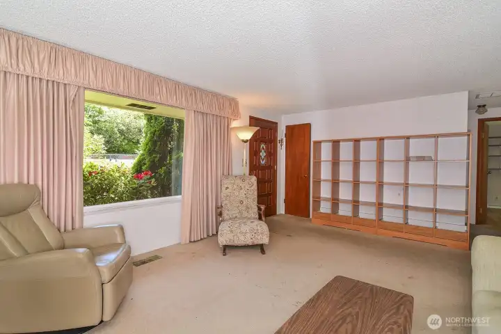 Living Room & Foyer. Original Hardwood floors under carpet as an option for buyer.