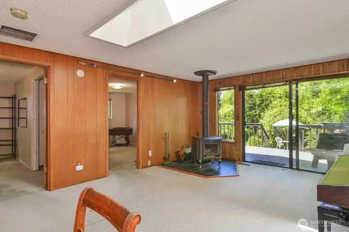 Family Room with Wood Fireplace and sliders to the deck.