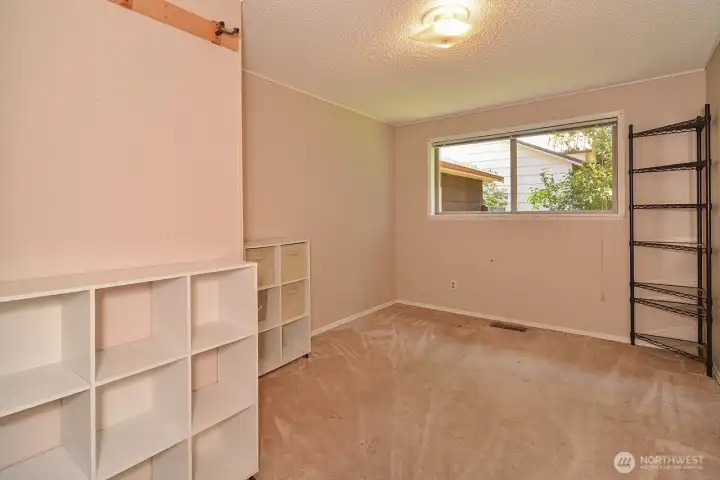 Bedroom 2. Original Wood floor under carpet as a great option.