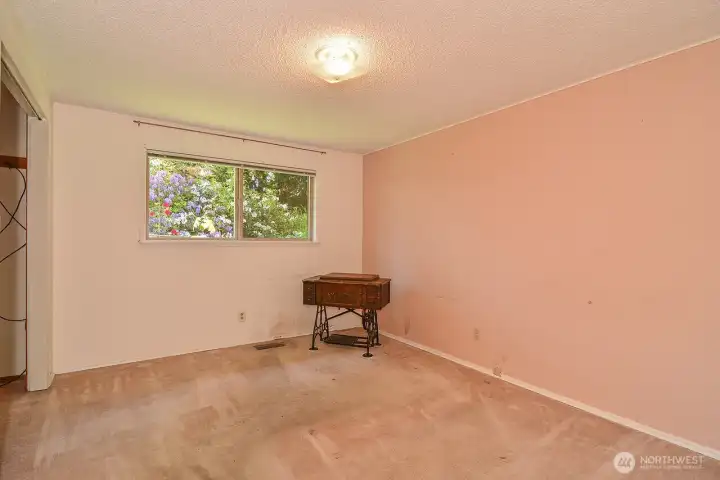 Bedroom 3. Original wood floors under carpet as a great option.