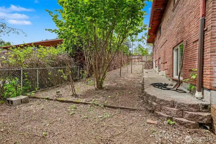 South side of house. Sliding gate at top of the slope.