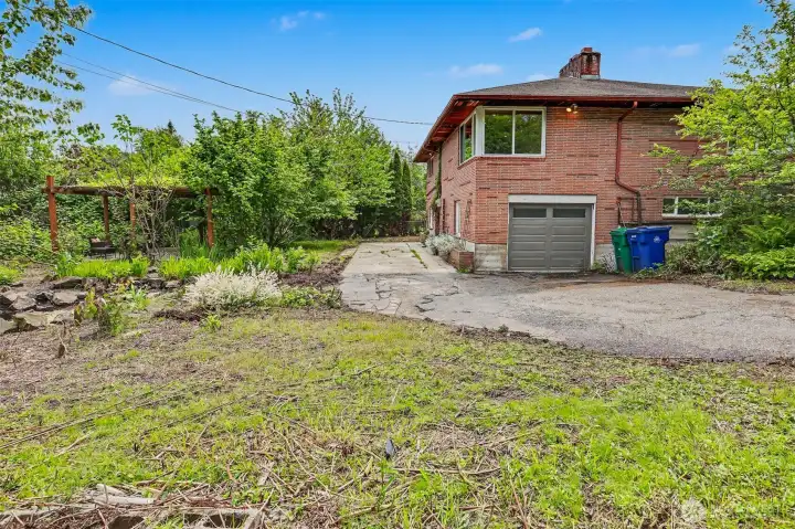 Bottom of driveway, garage and patio at east side of property.
