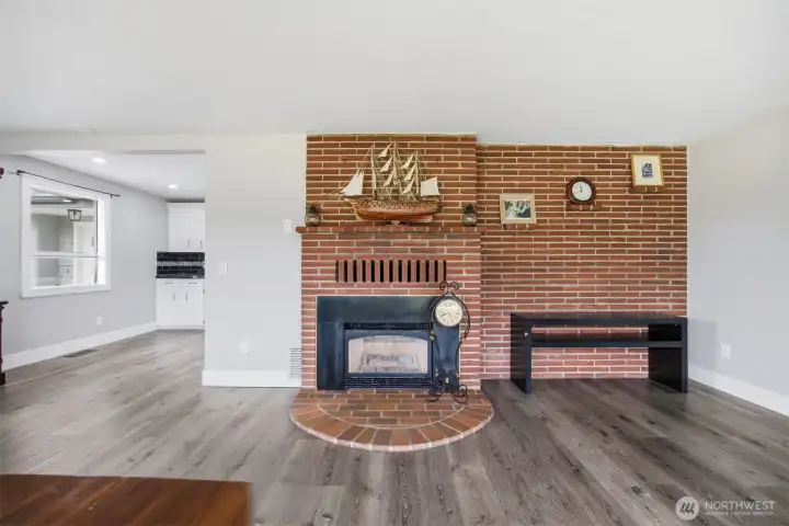 Classic mid-century brick accented gas fireplace adds character and warmth to the front room. Classic mid-century brick accented gas fireplace adds character and warmth to the front room.