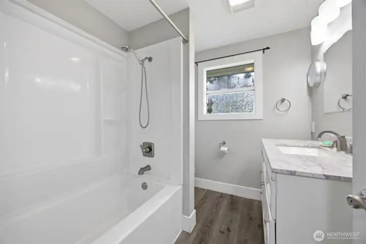 Clean updated bathroom has newer shower/bath surround. Easy care laminate floor and neutral decor calls for your personalized touches. Clean updated bathroom has newer shower/bath surround. Easy care laminate floor and neutral decor calls for your personalized touches.