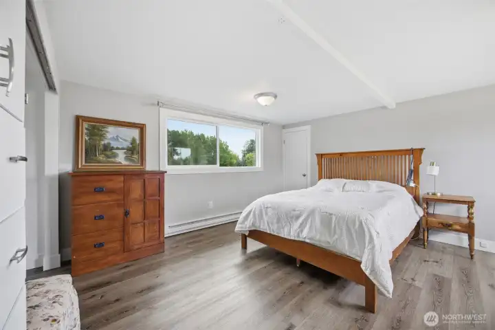 Spacious upper bedroom has dual closets, lots of space and natural light. Easy laminate flooring makes cleanup a breeze, giving a nice clean relaxing look. Spacious upper bedroom has dual closets, lots of space and natural light. Easy laminate flooring makes cleanup a breeze, giving a nice clean relaxing look.