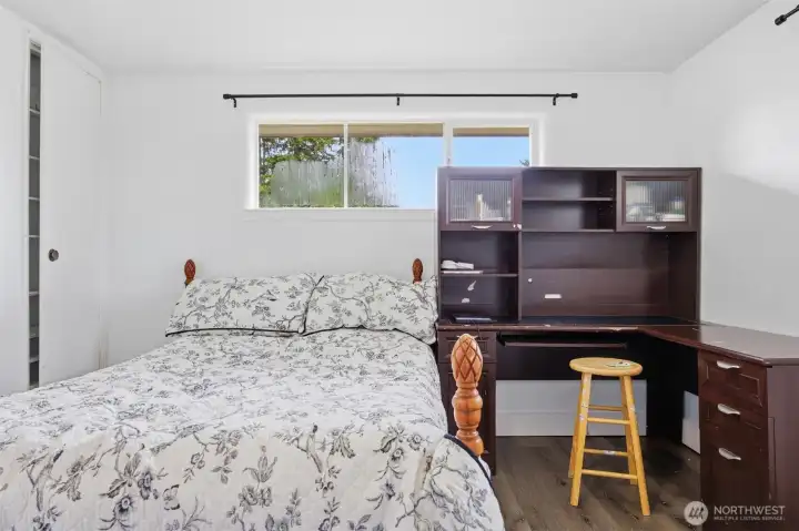 Downstairs bedroom with large closet and windows on two sides. Laminate flooring and fresh paint offers an enjoyable sanctuary. Downstairs bedroom with large closet and windows on two sides. Laminate flooring and fresh paint offers an enjoyable sanctuary.