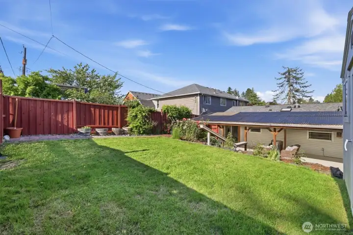 Level yard with lots of sun for gardening.