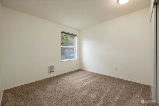 Second bedroom on left side of hallway, looks out to back of building.