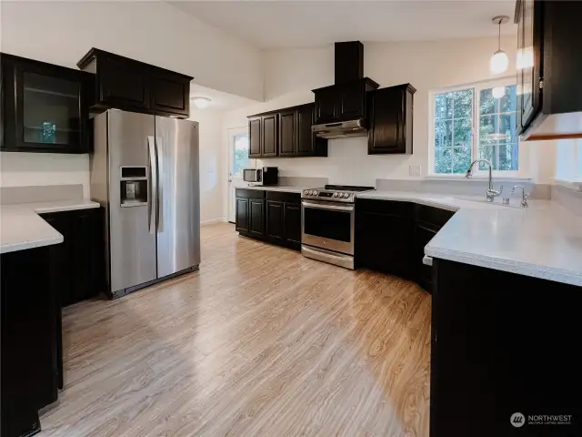 Spacious Kitchen with lots of cabinets and counter tops.