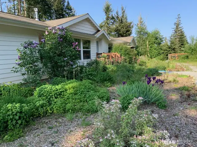Main home in summer with flowers in bloom