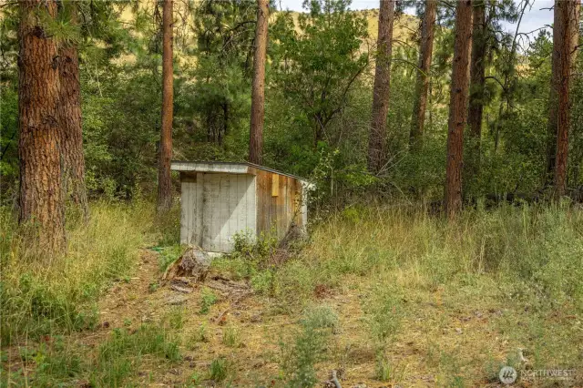 The well house is in the east corner of the property.