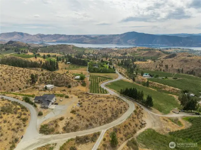 The neighbor to the left abuts the vacant land that follows the curve in the road on down to the orchard and worker housing.