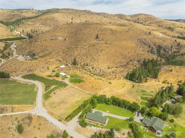 Across from the Orchard is a duplex used by employees of the Orchard.  One side is a two bedroom, 1 bath. The other side is one bedroom, one bath. Totally approximately 1200 sf.   This acreage includes the vacant land to the top of the narrow Orchard. It is approximately 1.36 acres --two tax parcels with amazing views of the Lake.  Great for more orchards or another residence.