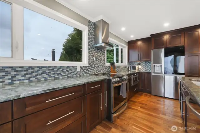 This chef's kitchen is a masterpiece of design and efficiency. It features high-end appliances, ample counter space, and custom cabinetry.