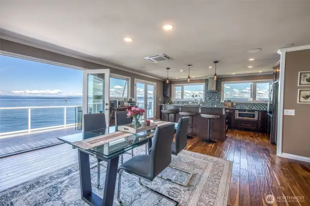 As you sit at the dining room table, enjoying a quiet breakfast, or perhaps hosting a candlelit dinner, the view out to the water is ever-present, expansive, and quietly captivating.