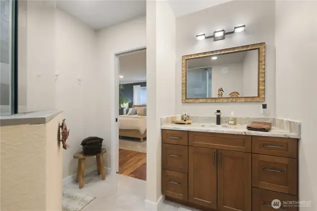 The en-suite bathroom offers spa-like comfort, with a stunning, custom walk in shower.