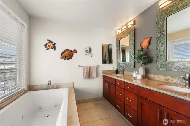 The primary bath is definitely a spa-inspired space that combines luxury and practicality. Set in a wide vanity-crafted from rich wood, the dual sinks provide ample room for two, making daily routines seamless and stress-free.