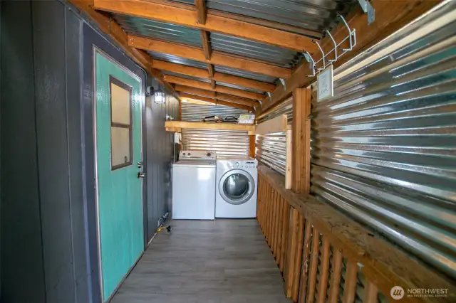 Covered and mostly enclosed space for washer and dryer
