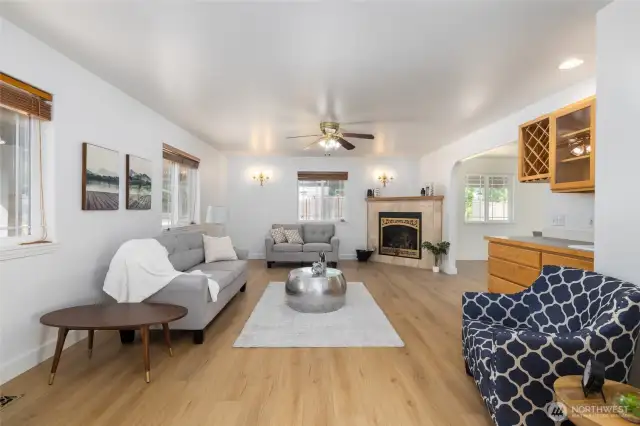 Open living room space with wet bar and fireplace.