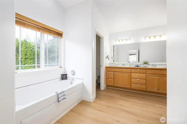 Primary ensuite bathroom has a jetted tub and walk-in shower.