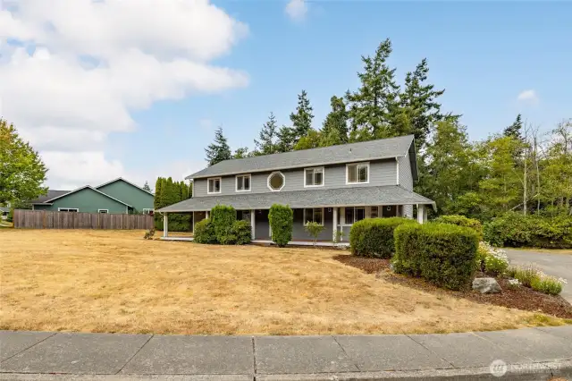 Open corner lot with mature landscaping.