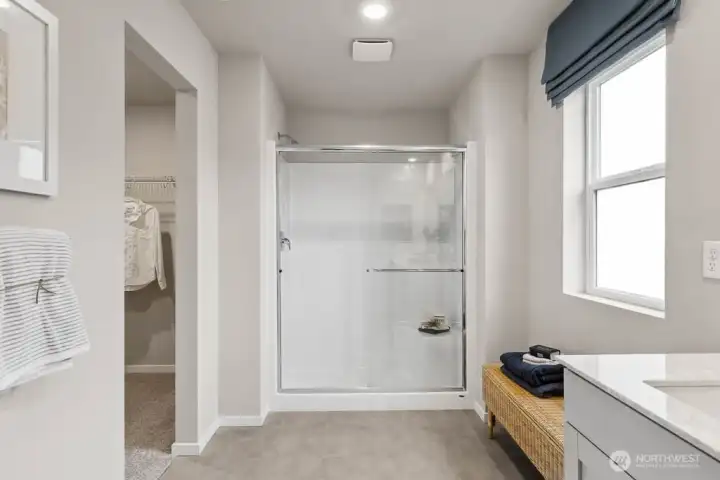 Ease of a step-in shower with built in bench off primary bedroom 1. Actual home is under construction. Colors, materials, and features may vary. See site agent for details.