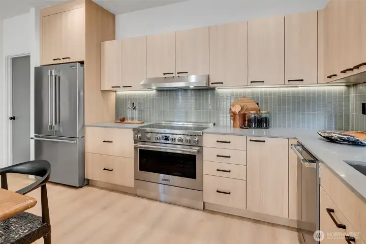 Bright, modern kitchen w/soft-close cabinets, luxury appliances & clean, minimalist design.