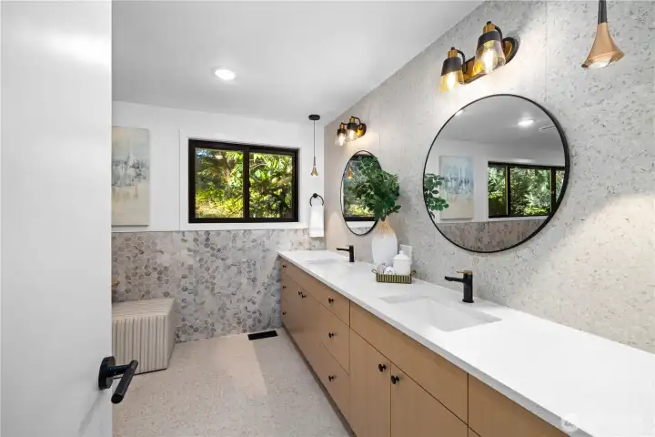Fully remodeled spa-inspired bath with dual vanities, quartz counters, designer lighting, and refined tile selections.