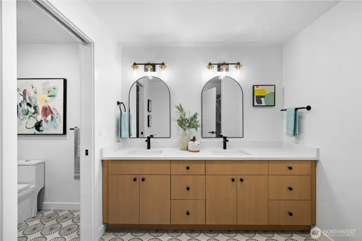Secondary bathroom with dual sinks, quartz surfaces, updated fixtures, and ample storage for everyday ease.