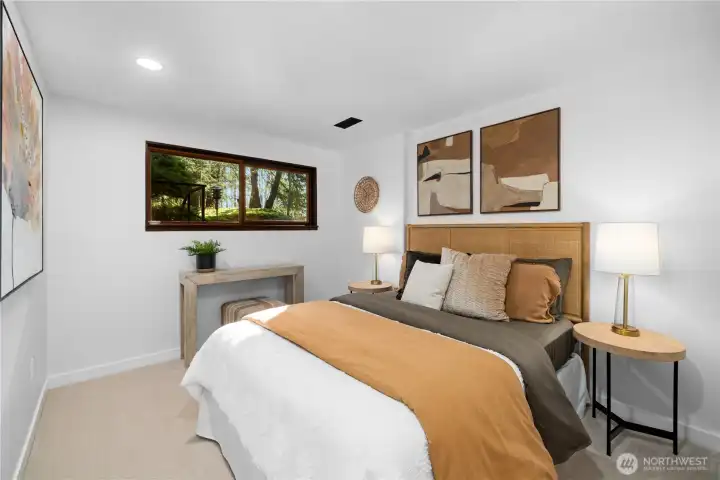 Comfortable lower-level bedroom with new carpet and updated finishes, providing a quiet retreat for guests or extended living.