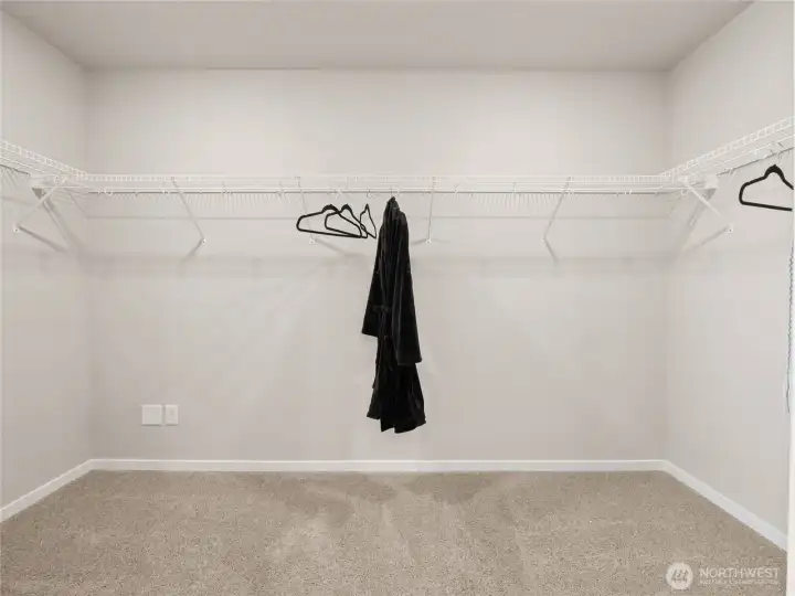 Walk in closet in primary bedroom.   Time to buy more clothes.  Photos are representative