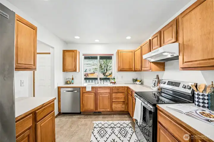 Kitchen off dining with oak cabinets. All appliances stay!