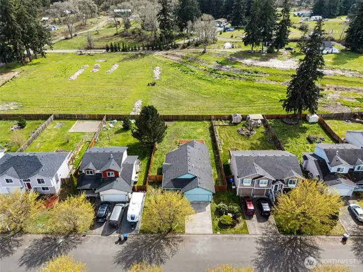 Open space behind the homes large backyard.