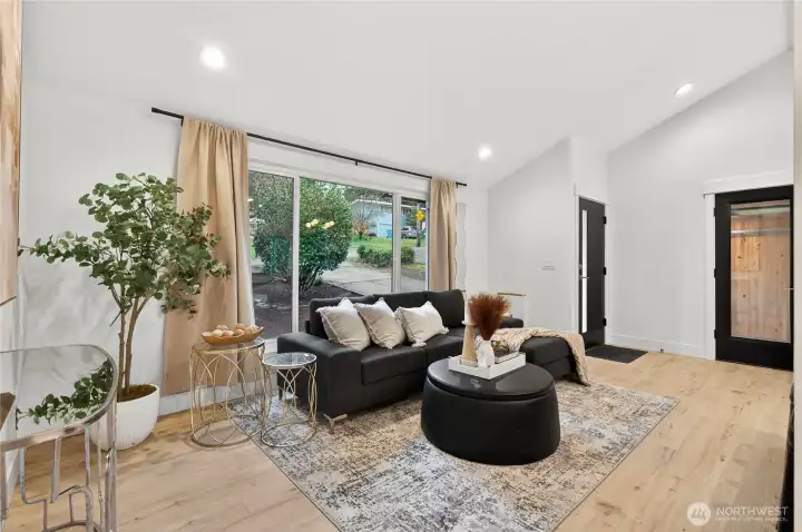 Recessed lighting throughout accentuates the vaulted ceiling architecture while providing layered illumination across living spaces in this professionally designed renovation.